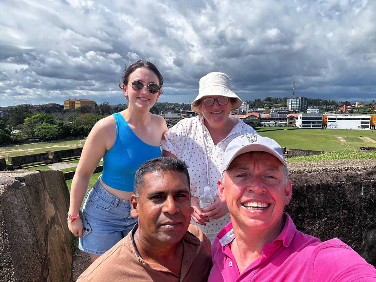 Happy tourists taking group selfie at magnificent waterfall – private Sri Lanka tour experience